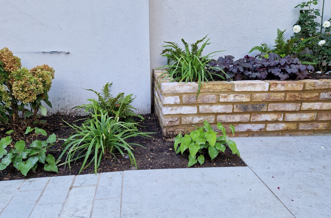 Planting areas and low brick raised bed